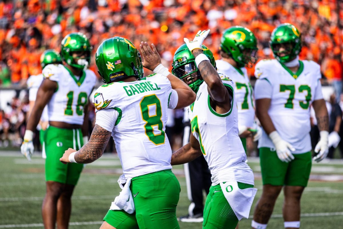 Dillon Gabriel (8) and Evan Stewart (7) celebrate another Oregon touchdown as they begin to widen their lead against the Oregon State Beavers. The Oregon Ducks travel up to Corvallis to face their in-state rival the Oregon State Beavers on September 14th, 2024. (Jonathan Suni/Emerald)