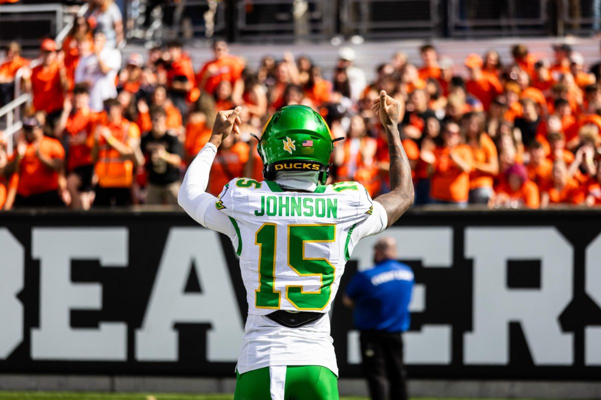 Tez Johnson (15) urges the Oregon State student section to keep yelling as he takes the field for warm ups. The Oregon Ducks travel up to Corvallis to face their in-state rival the Oregon State Beavers on September 14th, 2024. (Jonathan Suni/Emerald)