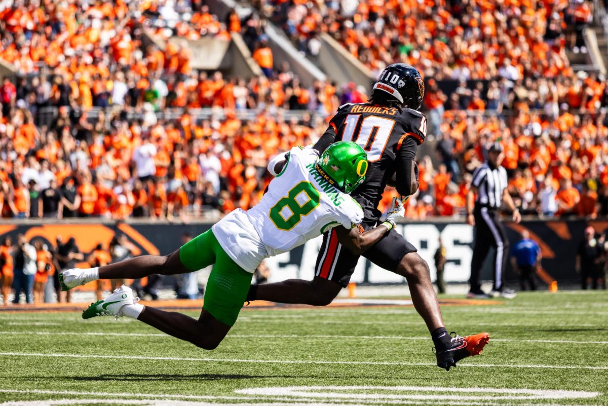 Long time Oregon Duck, Dontae Manning (8) , takes down a Beaver receiver with an open field tackle. The Oregon Ducks travel up to Corvallis to face their in-state rival the Oregon State Beavers on September 14th, 2024. (Jonathan Suni/Emerald)