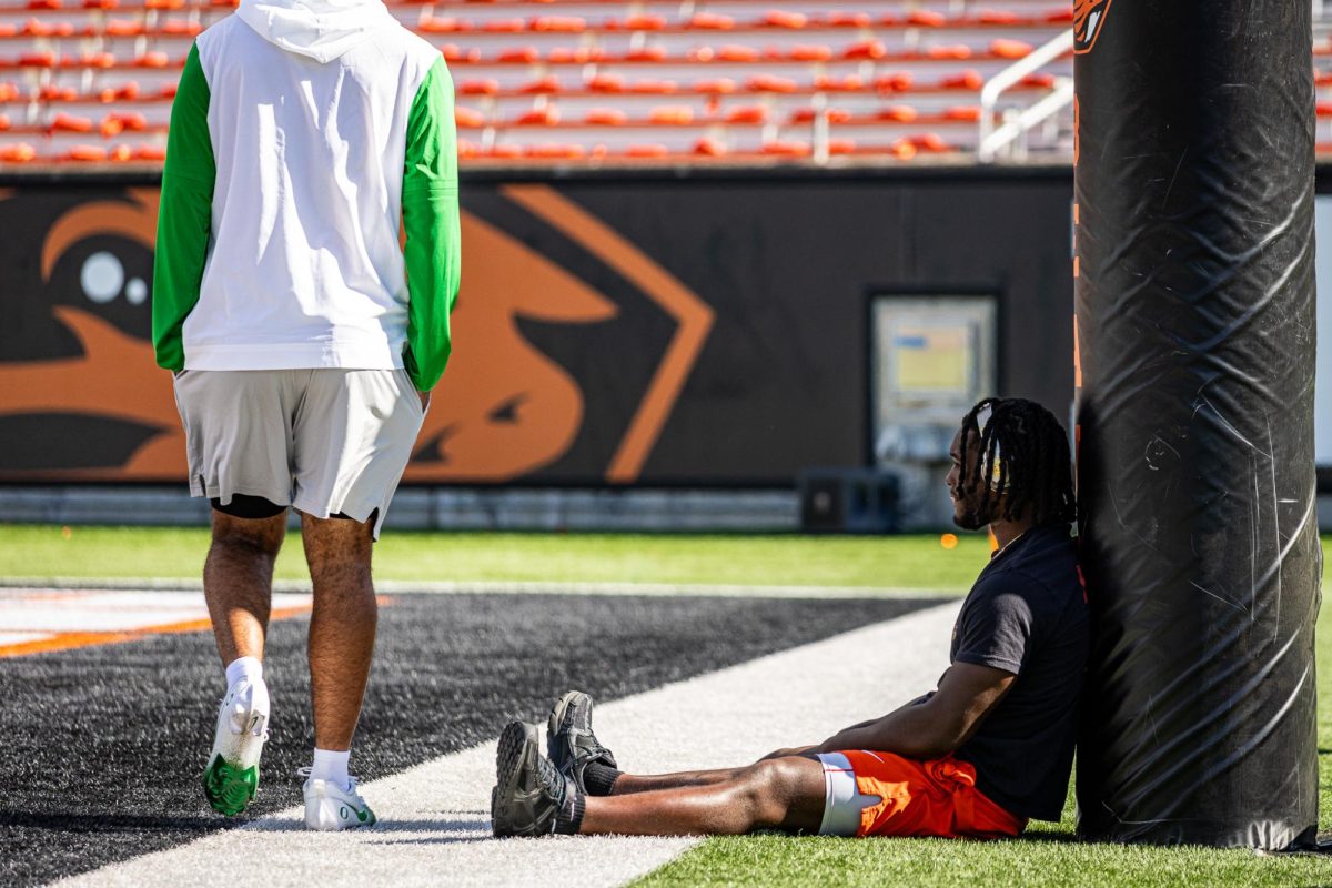 An Oregon State player sits and watches the Oregon Ducks participate in their individual warmups. The Oregon Ducks travel up to Corvallis to face their in-state rival the Oregon State Beavers on September 14th, 2024. (Jonathan Suni/Emerald)