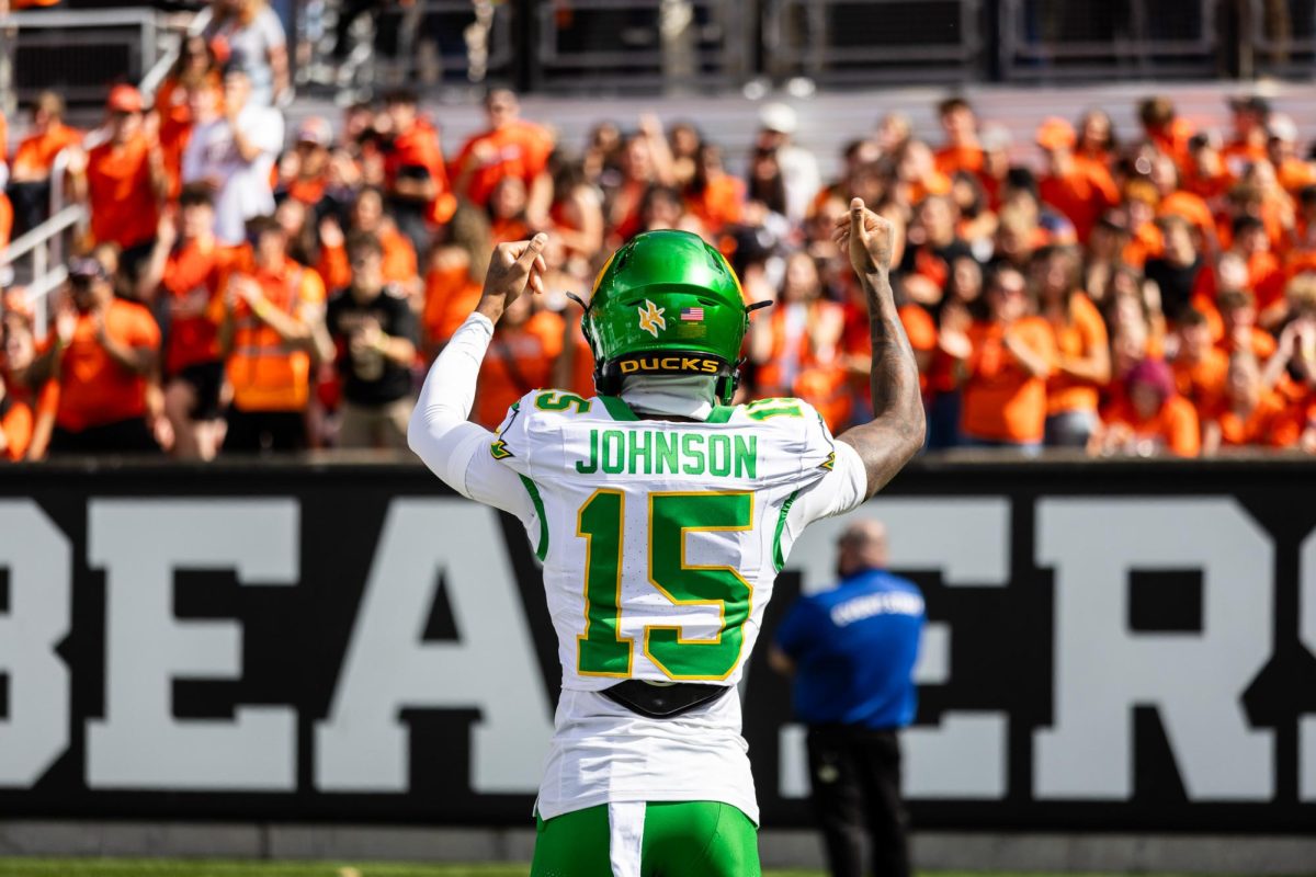 Tez Johnson (15) urges the Oregon State student section to keep yelling as he takes the field for warm ups. The Oregon Ducks travel up to Corvallis to face their in-state rival the Oregon State Beavers on September 14th, 2024. (Jonathan Suni/Emerald)