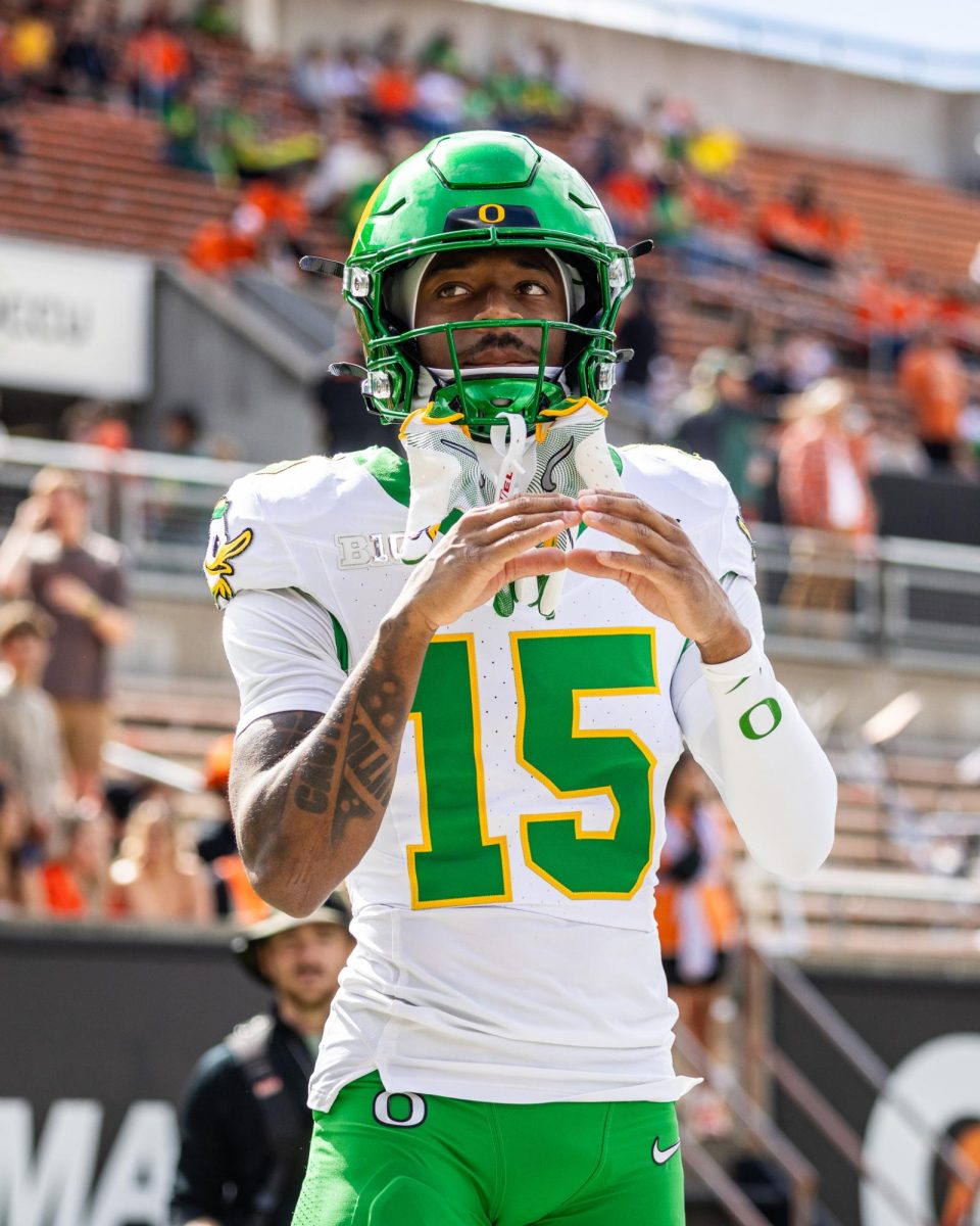 Tez johnson throws his "O" to a brave group of Duck fans who are sitting in the hostile Oregon State student section. The Oregon Ducks travel up to Corvallis to face their in-state rival the Oregon State Beavers on September 14th, 2024. (Jonathan Suni/Emerald)