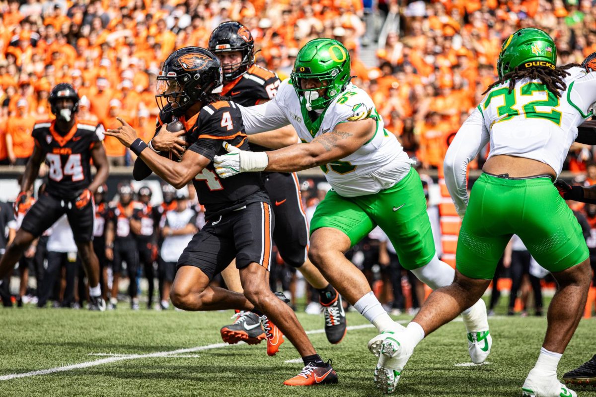 Derrick Harmon goes for a big sack against the Oregon State quarterback. Harmon has been an invaluable piece to the Oregon defensive line since transferring in from Michigan State. The Oregon Ducks travel up to Corvallis to face their in-state rival the Oregon State Beavers on September 14th, 2024. (Jonathan Suni/Emerald)