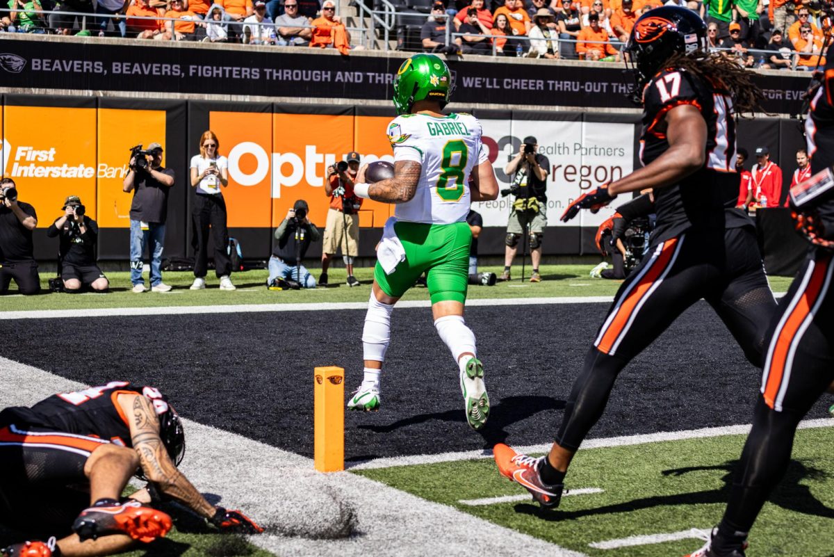 Dillon Gabriel (8) leaves a trail of disappointed Beavers as he walks into the end zone for the 54 yard rushing touchdown. The Oregon Ducks travel up to Corvallis to face their in-state rival the Oregon State Beavers on September 14th, 2024. (Jonathan Suni/Emerald)