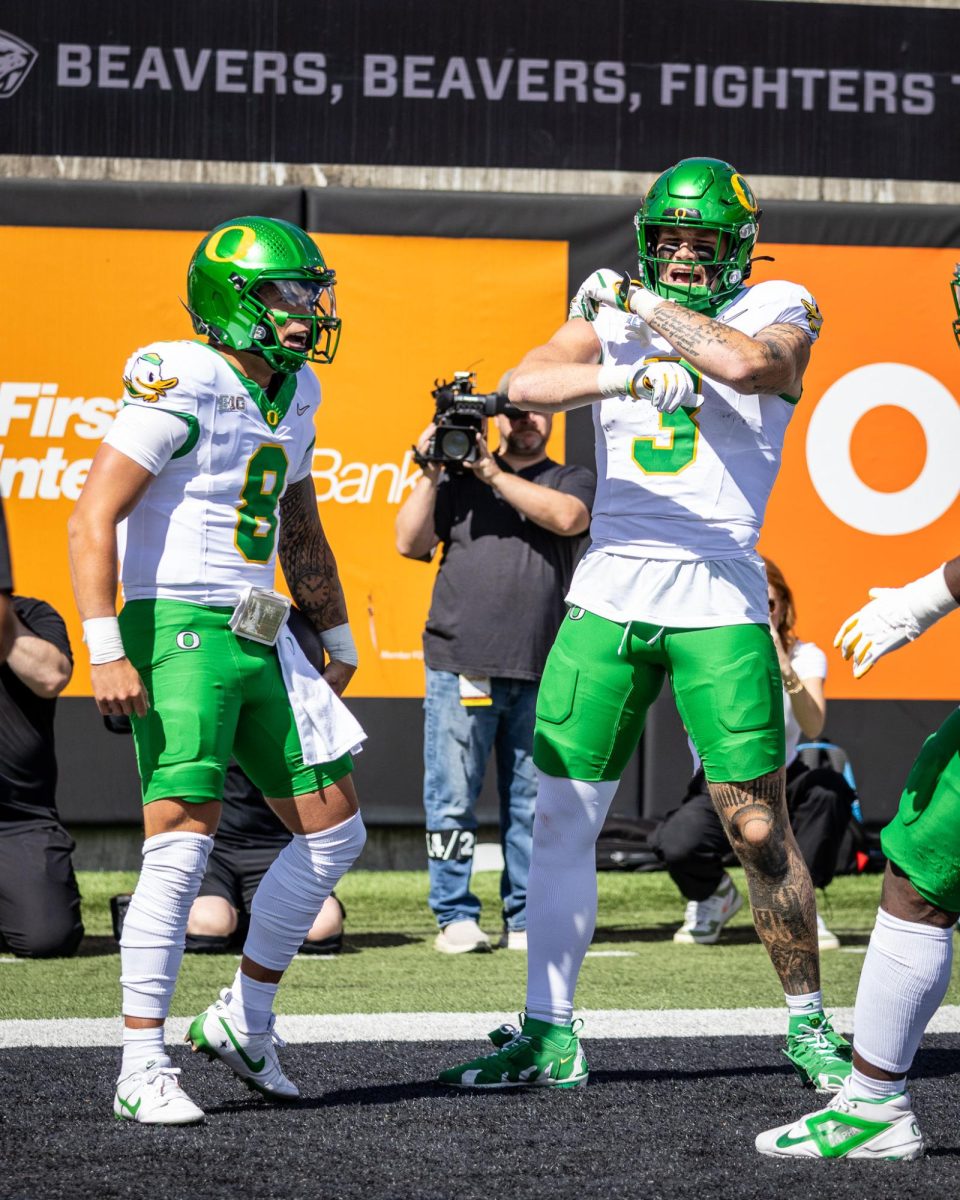 Dillon Gabriel (8) and Terrence Ferguson (3) celebrate the electric play made by the new QB1 for the Oregon Ducks. The Oregon Ducks travel up to Corvallis to face their in-state rival the Oregon State Beavers on September 14th, 2024. (Jonathan Suni/Emerald)