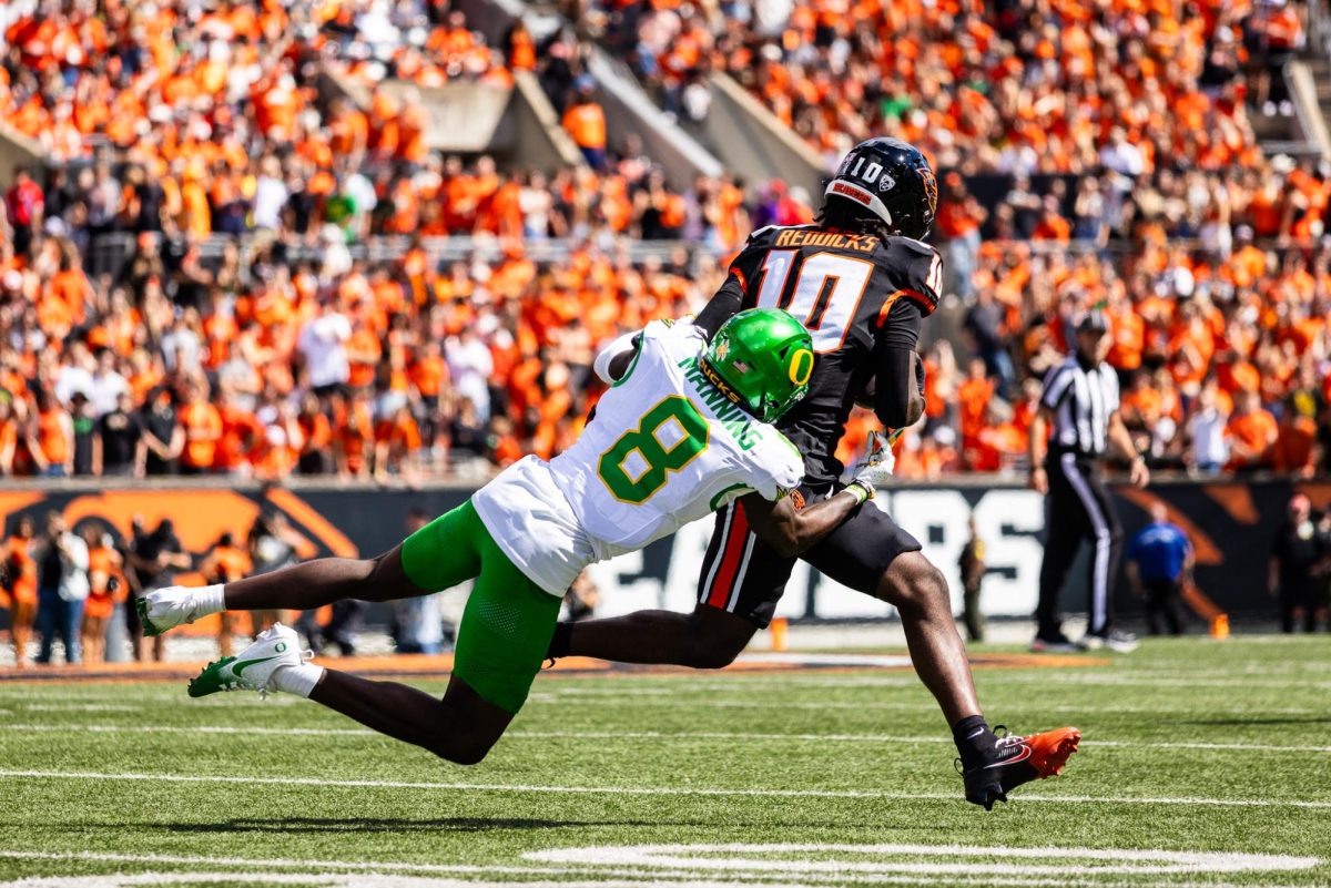 Long time Oregon Duck, Dontae Manning (8) , takes down a Beaver receiver with an open field tackle. The Oregon Ducks travel up to Corvallis to face their in-state rival the Oregon State Beavers on September 14th, 2024. (Jonathan Suni/Emerald)