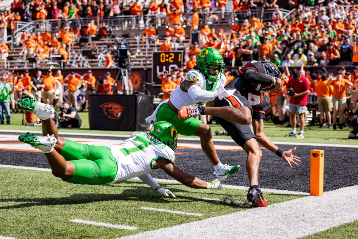 Jabbar Muhammad (7) and Kobe Savage (5) work to make a last chance stop at the goal line against the rushing Beaver quarterback. The Oregon Ducks travel up to Corvallis to face their in-state rival the Oregon State Beavers on September 14th, 2024. (Jonathan Suni/Emerald)