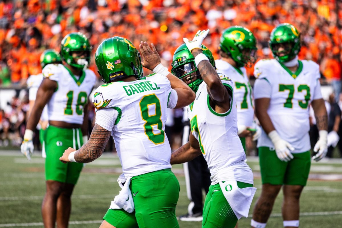 Dillon Gabriel (8) and Evan Stewart (7) celebrate another Oregon touchdown as they begin to widen their lead against the Oregon State Beavers. The Oregon Ducks travel up to Corvallis to face their in-state rival the Oregon State Beavers on September 14th, 2024. (Jonathan Suni/Emerald)