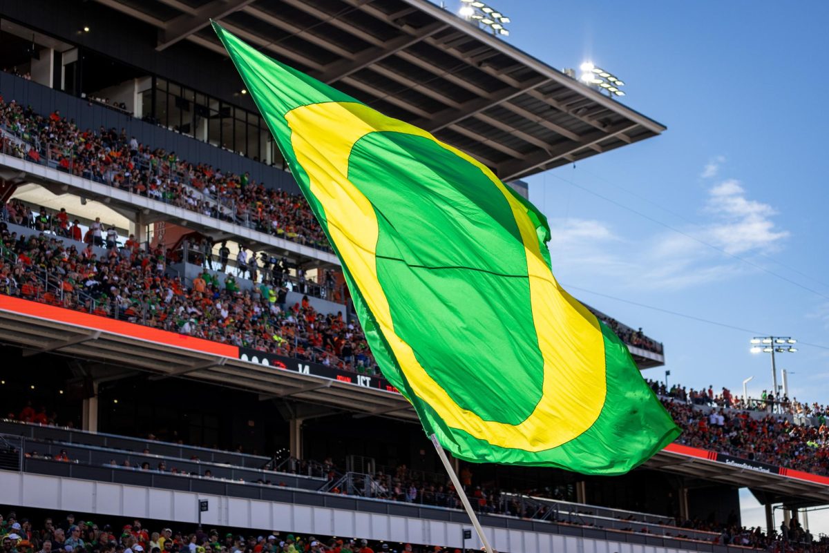 The Oregon cheer team proudly waves an Oregon flag in Beaver territory as the Ducks earn the title of "Oregon's Team" for another year. The Oregon Ducks travel up to Corvallis to face their in-state rival the Oregon State Beavers on September 14th, 2024. (Jonathan Suni/Emerald)