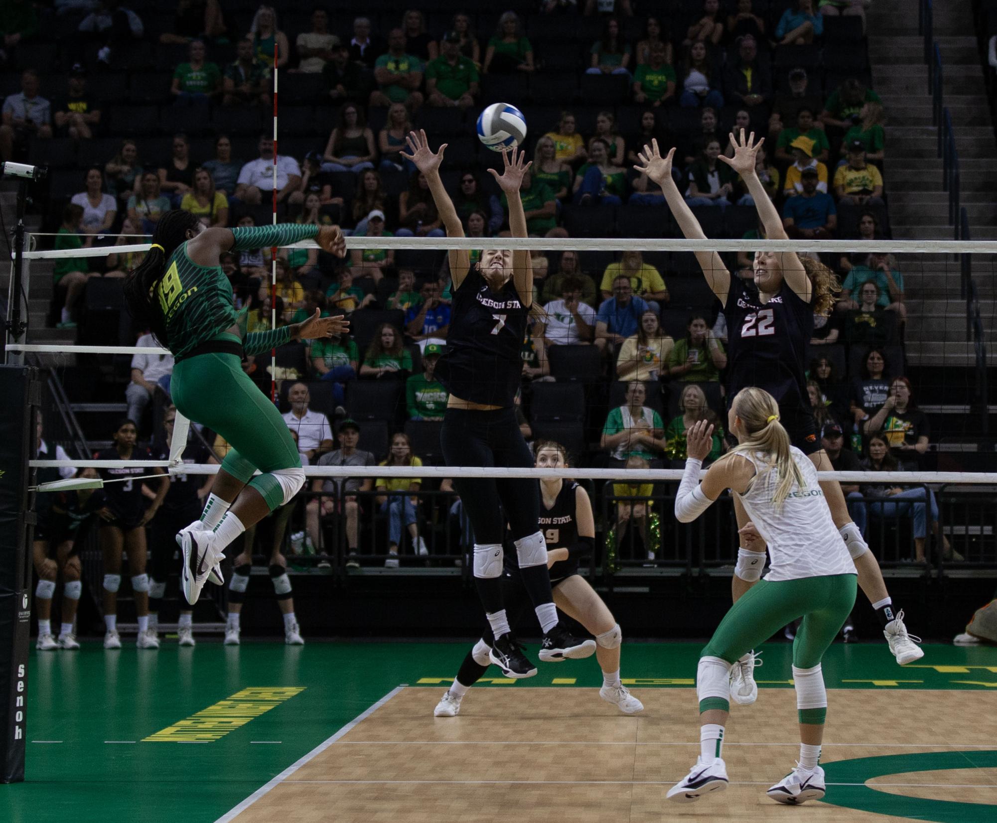 Michelle Ohwobete (19) jumps to shoot the ball towards Amanda Burns (7) and Kalli Schoening (22). The University of Oregon Ducks crushed the Oregon State Beavers 3-0 Sunday. (Miles Cull/Emerald)