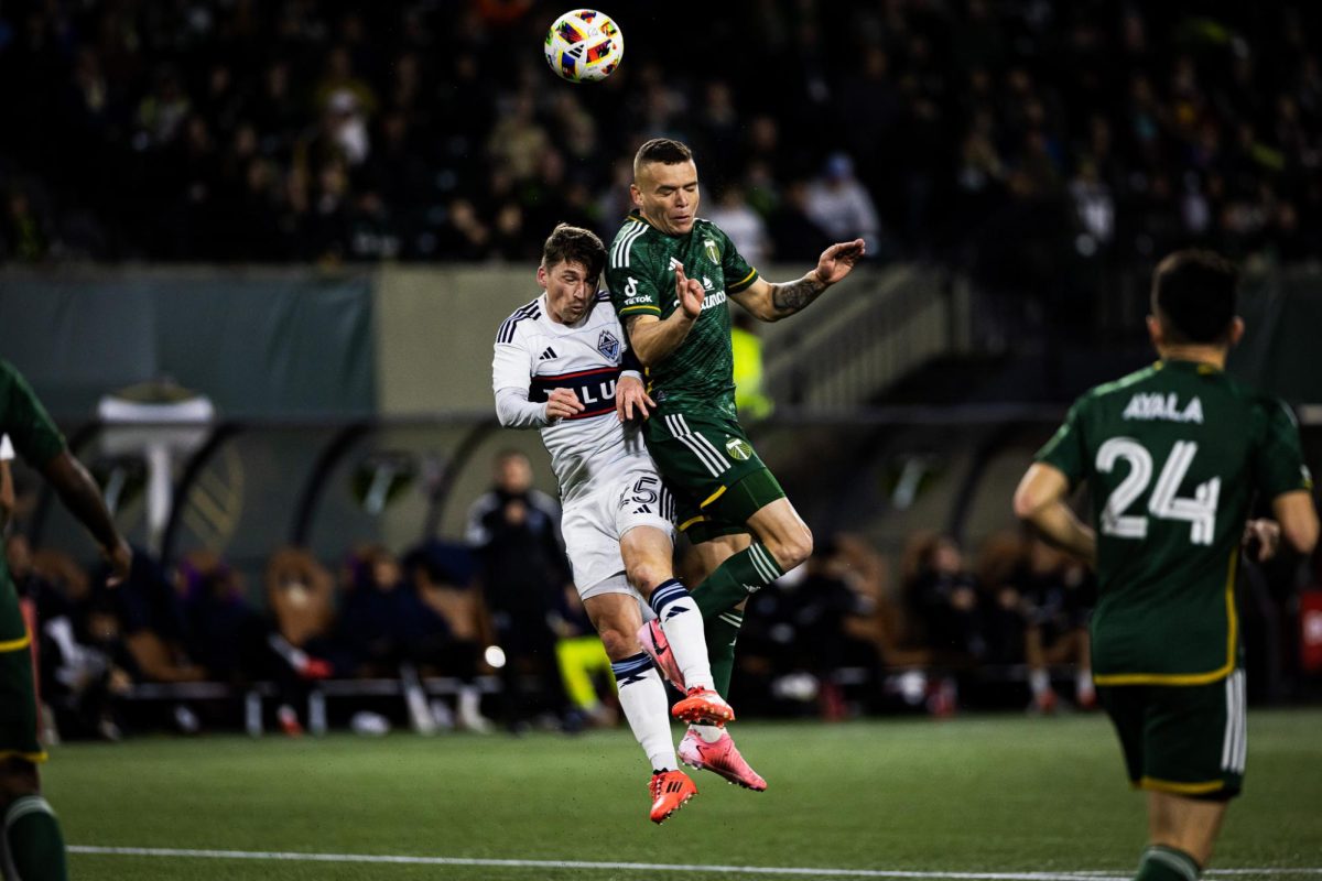 Jonathan Rodríguez (14) collides with a Vancouver player as he looks to head the ball to a teammate. The Portland Timbers Football Club hosts the Vancouver Whitecaps at Providence Park in Portland, Ore., on Oct. 23, 2024 for the wildcard round of the MLS Playoffs. (Jonathan Suni/Emerald)
