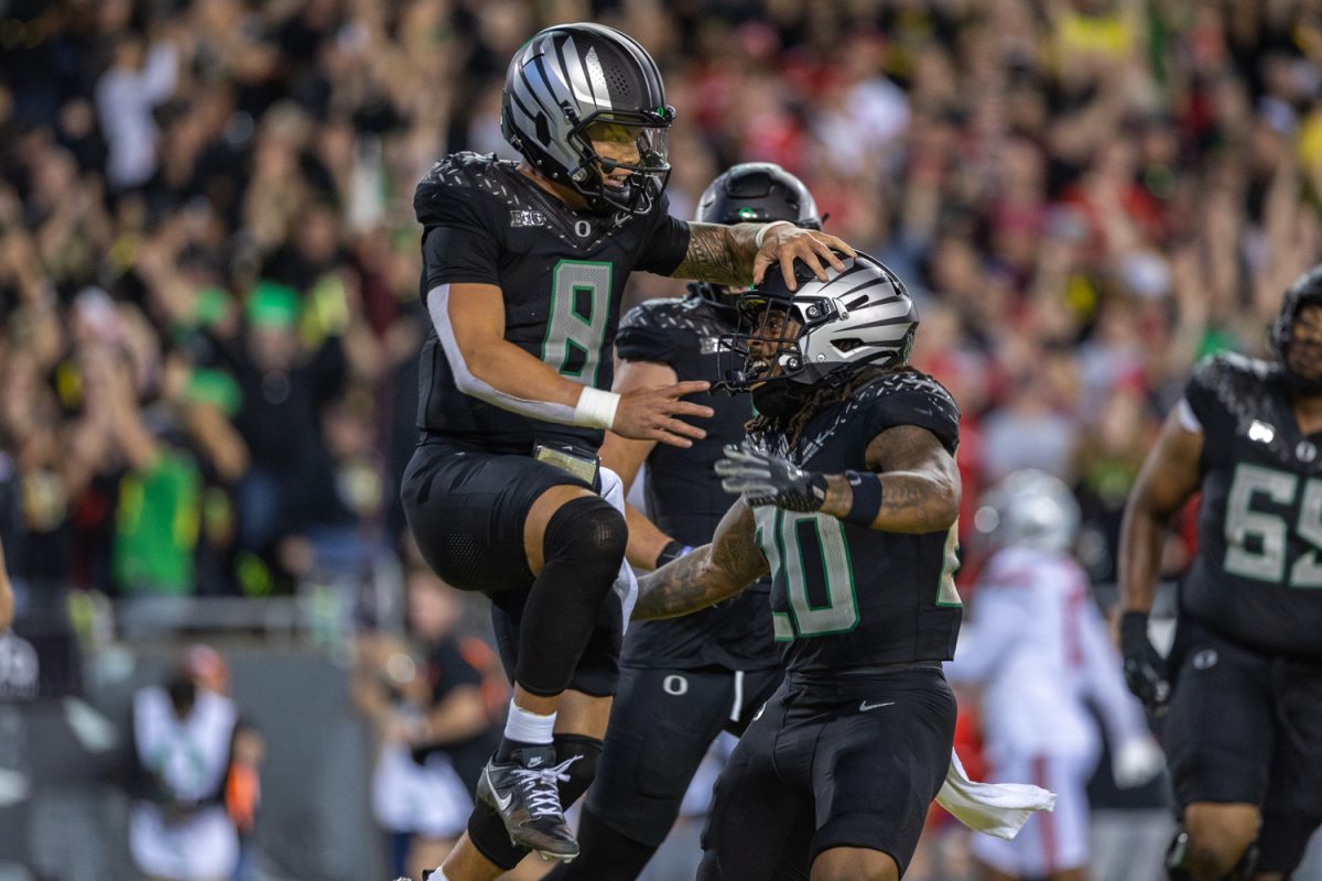 Dillon Gabriel (8) celebrates with his ofeense after he runs in for a touchdown. The number 3 ranked Oregon Ducks football team takes on the number 2 ranked Ohio State University Buckeyes on Oct. 12, 2024, at Autzen Stadium in Eugene, Ore. (Molly McPherson/Emerald)