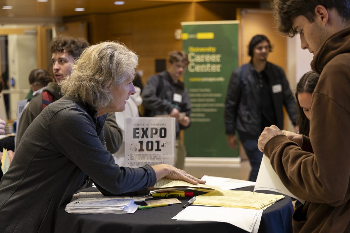 A student checks in and gets a name tag. Students, staff and potential employers attended the UO Career Center's Fall Career and Internship Expo on Oct. 24, 2024. (Alex Hernandez/Emerald)