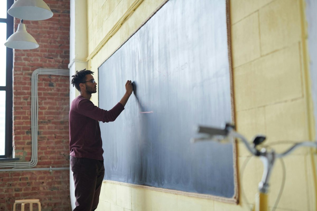 https://www.pexels.com/photo/man-writing-on-a-blackboard-3184658/