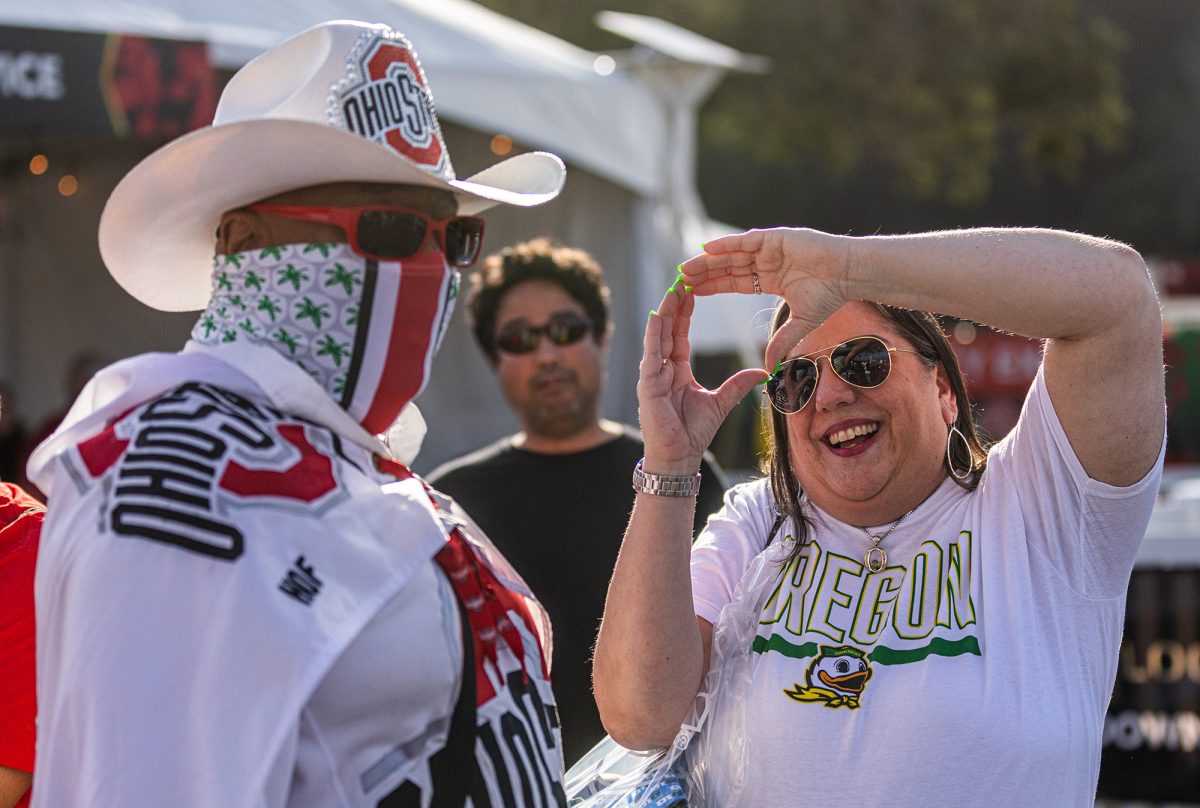 Fans attend the Rose Bowl Bash outside the Rose Bowl Stadium in Pasadena, Calif., on Dec. 31, 2024, ahead of the CFB Quarterfinal between the Oregon Ducks and Ohio State Buckeyes. The event featured live entertainment, food vendors, and pregame activities for fans of both teams. (Max Unkrich / Emerald)