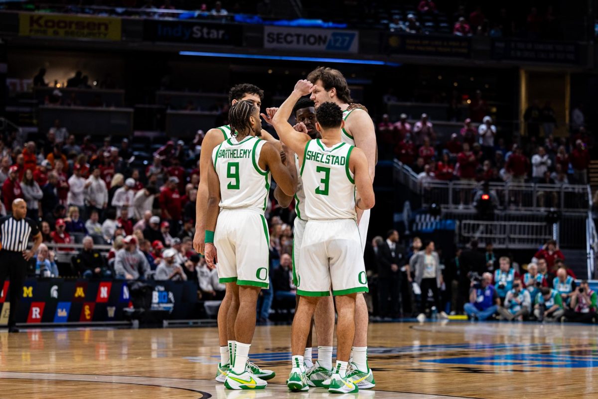 The starting five Ducks meet center court as they prepare for tip-off against the Indiana Hoosiers. The Oregon Ducks take on the Indiana Hoosiers in the second round of the Big Ten Tournament at Gainbridge Fieldhouse in Indianapolis, IN, on March 13, 2025. (Jonathan Suni/Emerald)