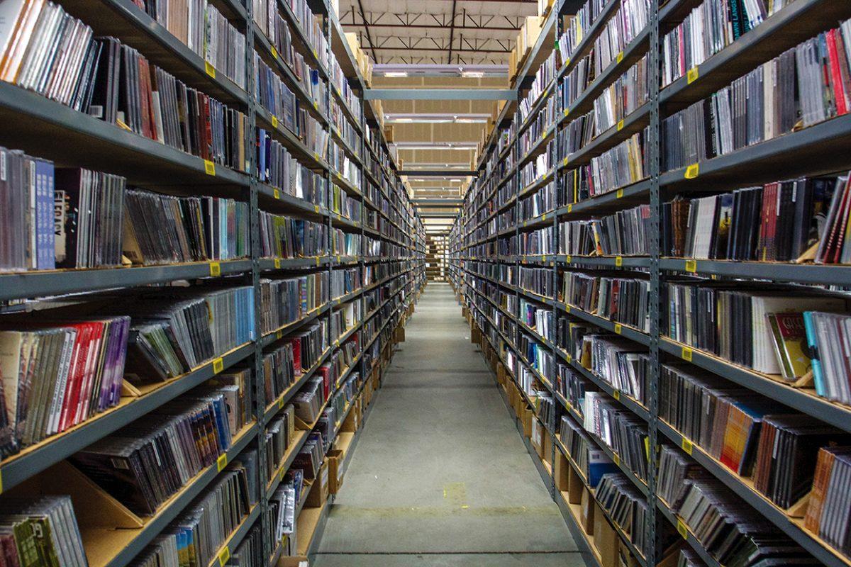 Seemingly endless rows line CD Baby&#8217;s warehouse in Portland, Oregon. These rows archive music that has been, or will be, distributed by the label.