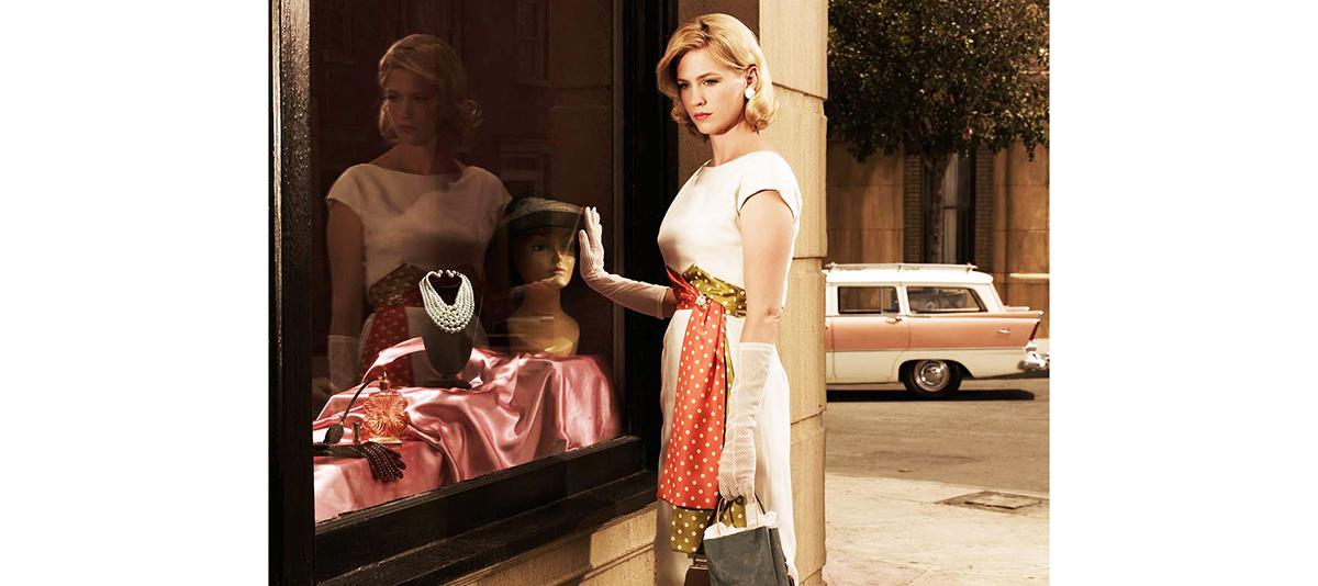 Betty Draper of Mad Men is most often in full skirts with a matching blouse and a silk scarf as her major accessory- definitely a Grace Kelly look. (Courtesy of AMC)