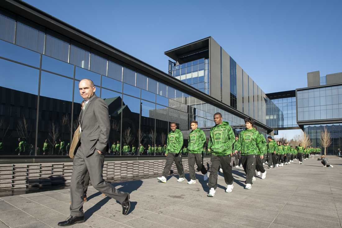 Oregon Ducks head coach Mark Helfrich walks the team out of the Hatfield Dowlin Complex. (Cole Elsasser/Emerald)