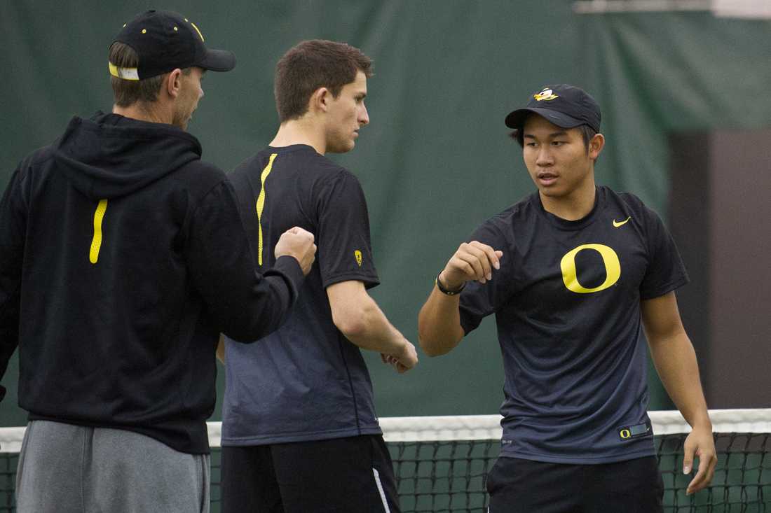 Armando Soemarno goes to shake hands with Assistant Coach Jonas Piibor before the start of his doubles match. The No. 49 Oregon Ducks face the No. 54 UC Santa Barbara Gauchos at the Oregon Student Tennis Center in Eugene, Ore. on Jan. 19 2016.