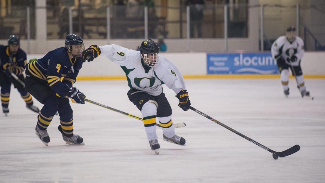 Oregon forward Nick Sciabarra (9) escapes on a breakaway with the puck as he is pursued by California defenseman Alex Pelletier (9). The Oregon Ducks face the California Golden Bears at the Lane County Ice Center in Eugene, Ore. on Jan. 30 2016. (Adam Eberhardt/Emerald)