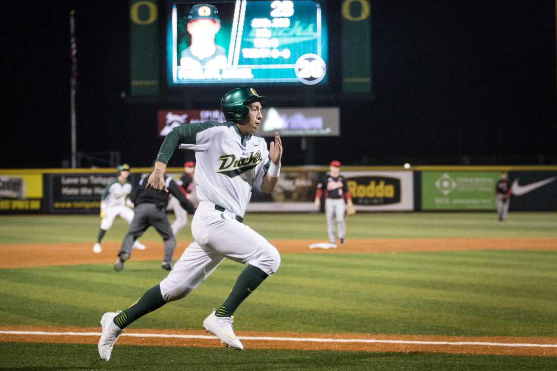 Matt Kroon (21) scores a run. The Oregon Ducks face the Illinois State Redbirds at PK Park in Eugene, Ore. on Feb. 26, 2016. (Samuel Marshall/Emerald)