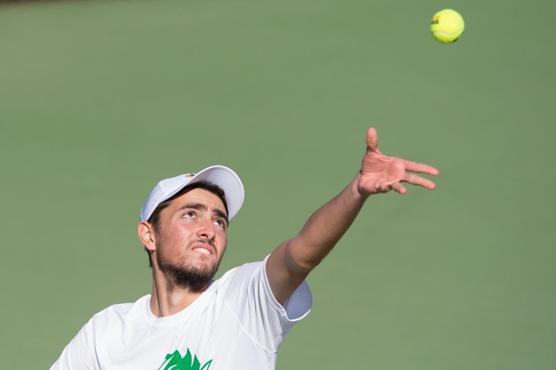 Thomas Laurent throws the ball up to serve during his singles match. The No. 39 Oregon Ducks take on the Arizona Wildcats at the Oregon Student Tennis Center in Eugene, Ore. on April 1, 2016. (Adam Eberhardt/Emerald)