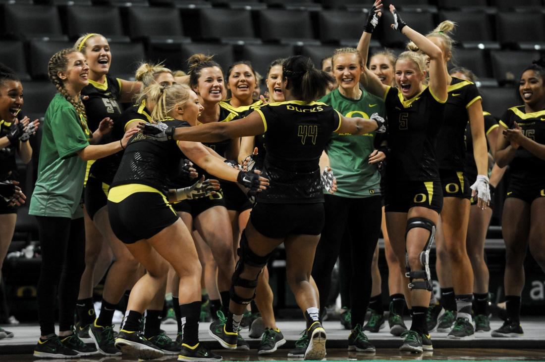 Members of the Oregon Acrobatics and Tumbling team welcome Oregon base Sydnee Walton (44) after she completes her tumbling event. The No. 1 Oregon Ducks face the No. 2 Baylor Bears at Matthew Knight Arena in Eugene, Ore. on March 31, 2016. (Kaylee Domzalski/Emerald)