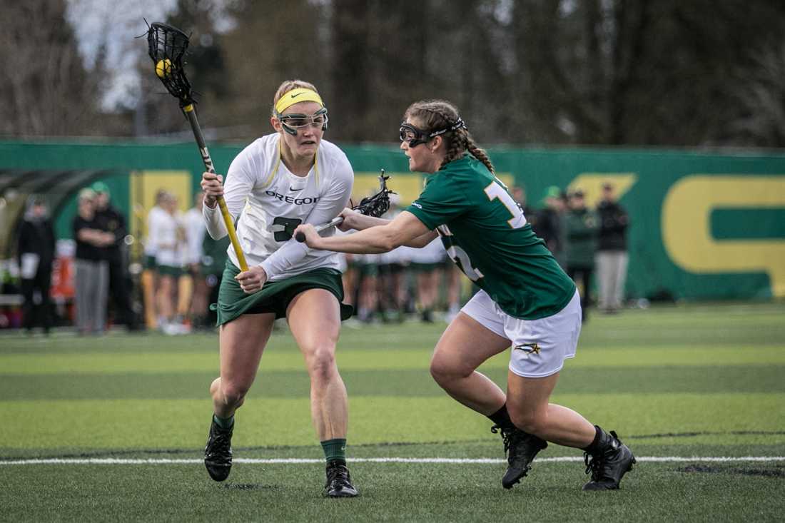 Natalie Modly (9) tries to shake her defender off. The University of Oregon Women&#8217;s Lacrosse team hosted George Mason university at Pap&#233; Field on March 9, 2016. (Samuel Marshall/Emerald)