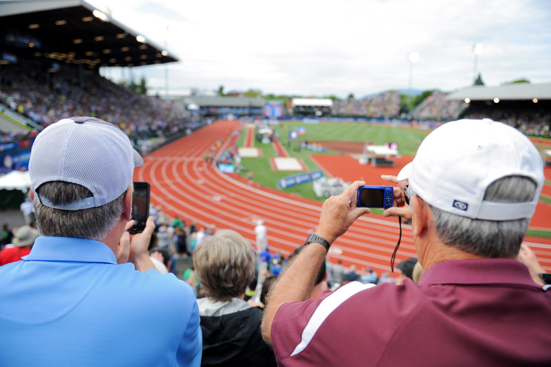 Spectators take photos of the 5,000 meters. The Track and Field Olympic Trials are held at Hayward Field in Eugene, Ore. on July 9, 2016. (Kaylee Domzalski/Emerald)