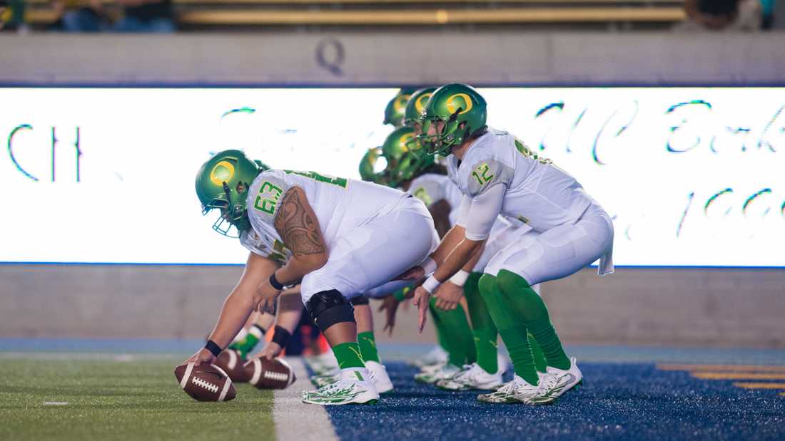 Oregon offensive lineman Davis Miyashiro-Saipaia (63) warms up hutting the ball. The Oregon Ducks play the California Bears at California Memorial Stadium in Berkeley, Calif. on Oct. 21, 2016. (Amanda Shigeoka/Emerald)