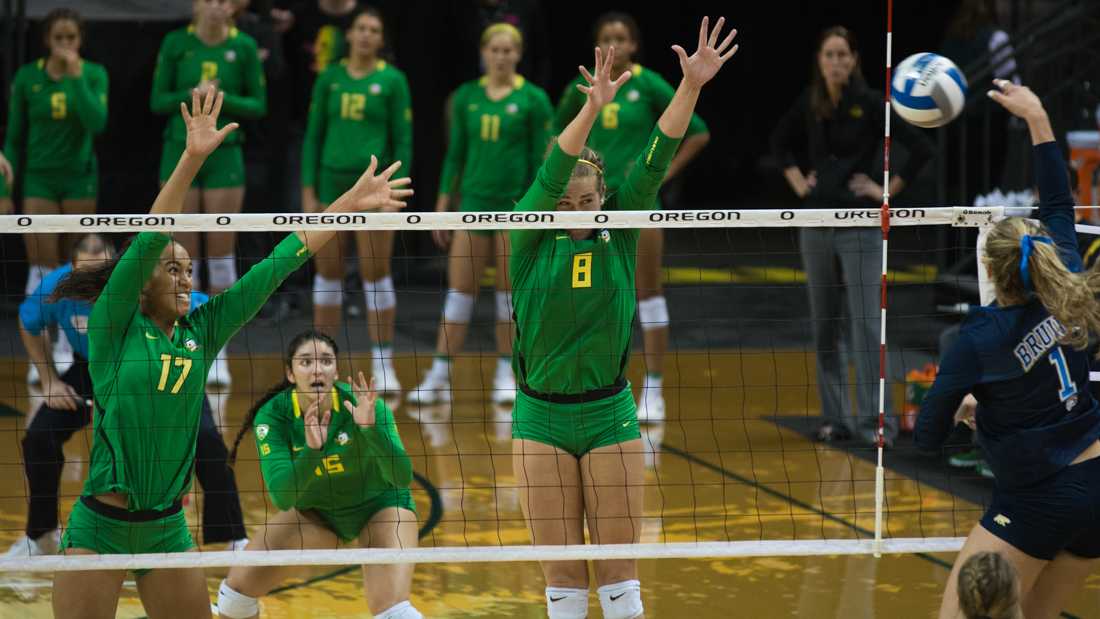 Ronika Stone (17) and Lindsey Vander Weide (8) fight to keep their eyes open as Jordan Anderson (1) attempts to spike the ball. The Ducks host the Women of UCLA Bruins in Volleyball at Matthew Knight Arena on Oct. 12, 2016. (Amanda Shigeoka/Emerald)