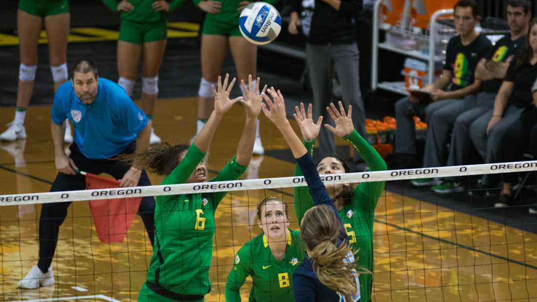 Lindsey Vander Weide (8) keeps her eyes on the ball as Lauren Page (6) and Jolie Rasmussen (15) block the ball. The Ducks host the Women of UCLA Bruins in Volleyball at Matthew Knight Arena on Oct. 12, 2016. (Amanda Shigeoka/Emerald)