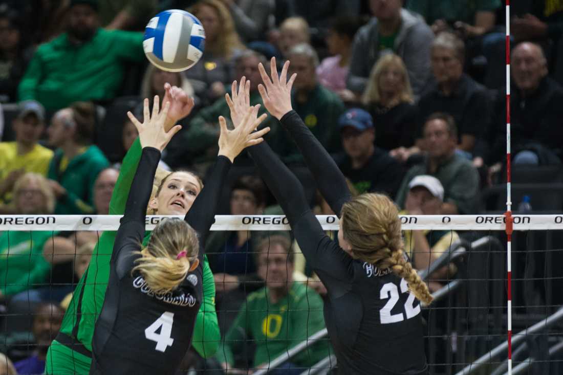 Oregon outside hitter Taylor Agost (7) spikes the ball past the block. The Ducks host the University of Colorado Boulder Buffs in Volleyball for their senior night at Matthew Knight Arena on Nov. 10, 2016. (Amanda Shigeoka/Emerald)