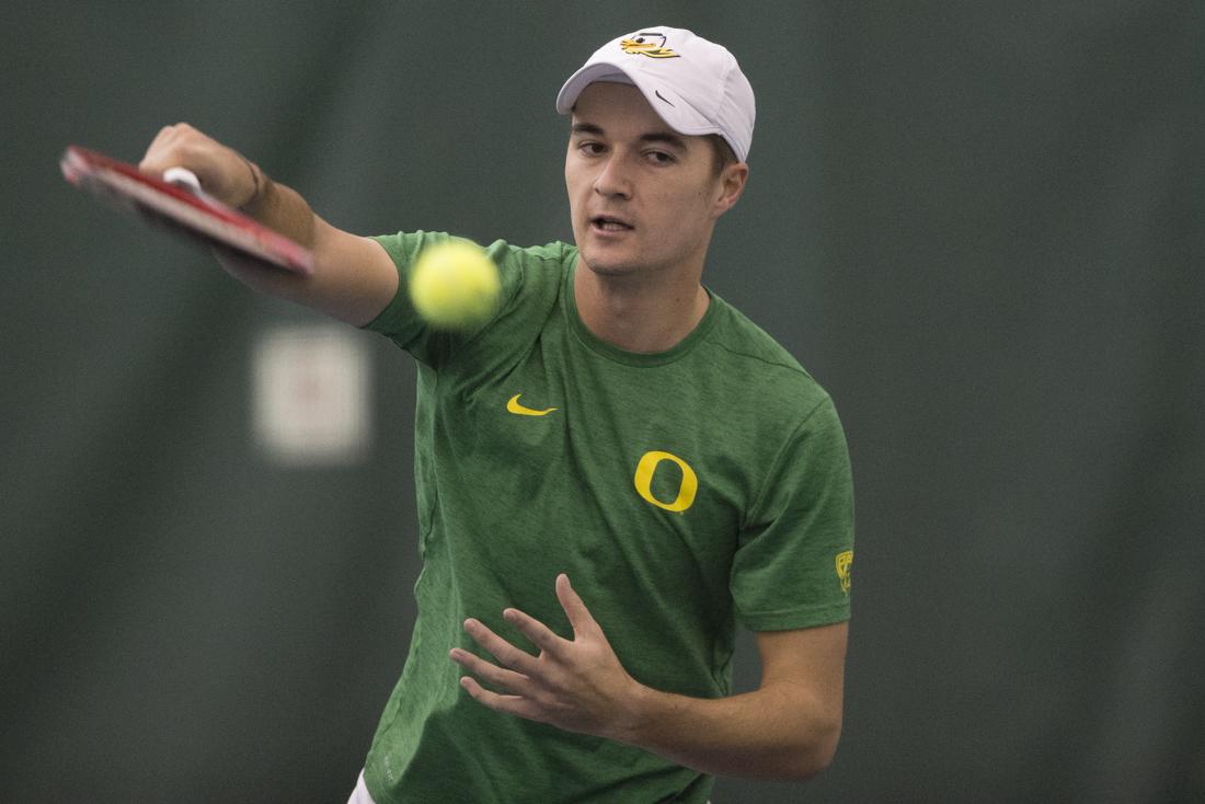 Jayson Amos spikes the ball over the net during his singles match. The Oregon Ducks play Montana State Bobcats at the Oregon Student Tennis Center in Eugene, Ore. on Sunday, January 22, 2017. (Adam Eberhardt/Emerald)