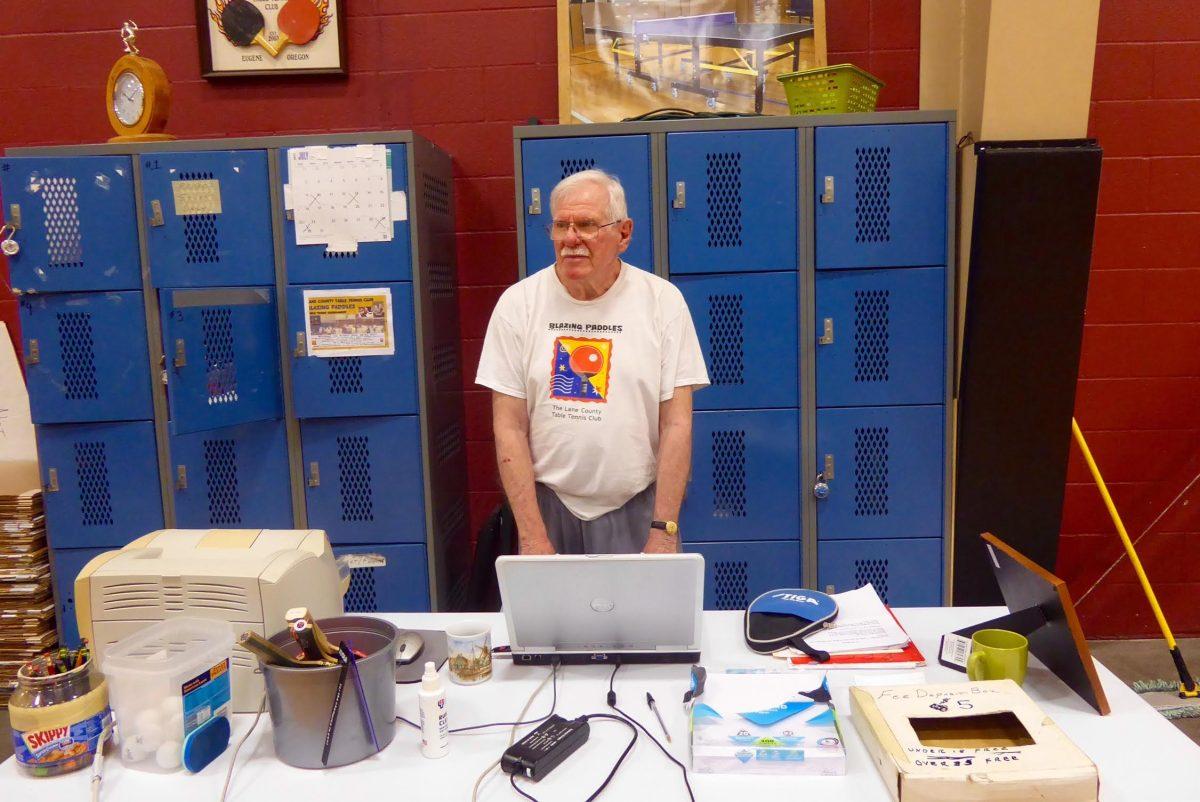 Blazing Paddles president Dave Combs runs the check-in table at the table tennis club&#8217;s regular meetings. (Julia Taylor/Emerald)