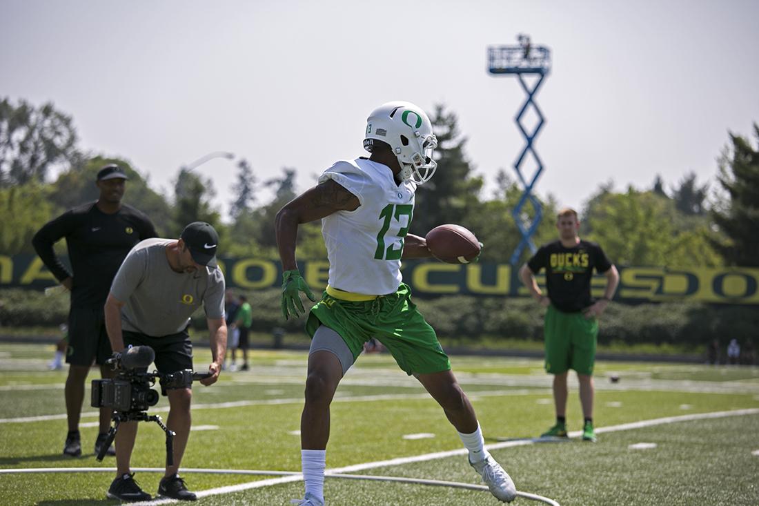 Sophomore wide receiver Dilon Mitchell (13) makes a one-handed grab at Oregon Football training camp. (Theo Mechain/Emerald)