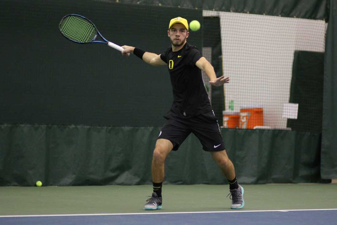 Oregon Ducks Simon Stevens reaches out for the return during his singles match. The Oregon Ducks face the Portland State Vikings at the Oregon Student Tennis Center in Eugene, Ore. on January 12, 2018. (Devin Roux/Emerald)