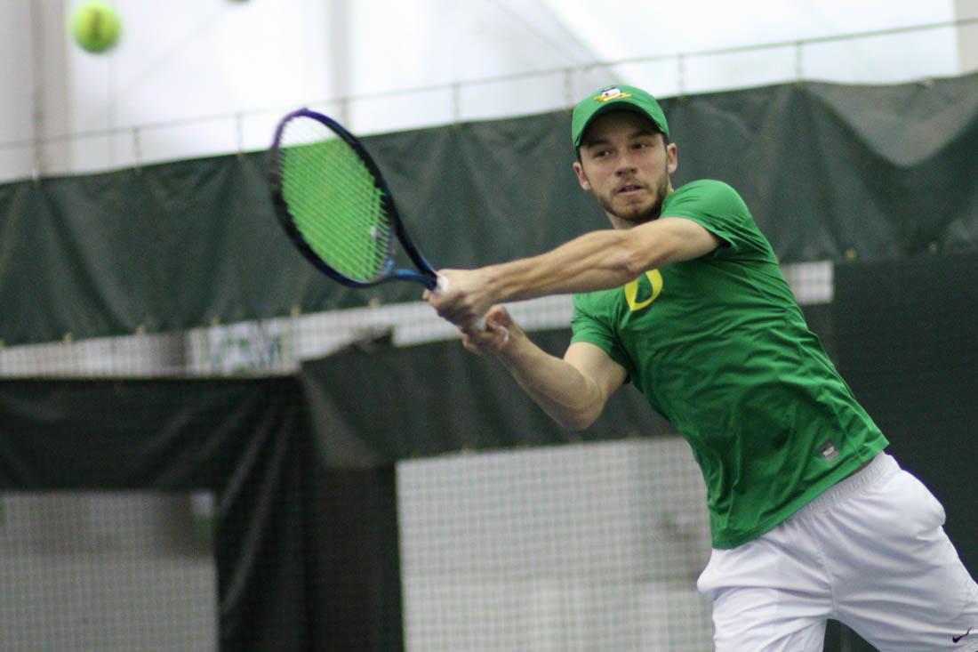 Oregon Ducks Simon Stevens hits the ball back during his singles match. The Oregon Ducks face the Northern Arizona University Lumberjacks at the Oregon Student Tennis Center in Eugene, Ore. on Feb. 24, 2018. (Devin Roux/Emerald)