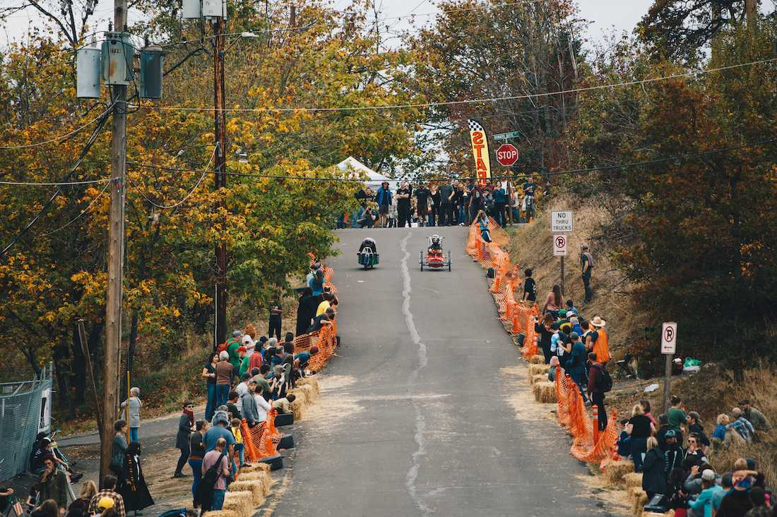 Two competitors begin the race, starting at the top of a hill by the Skinner Butte columns and heading down Lincoln Street. EUGFun! hosts its inaugural Halloween-themed soap box derby, the Coffin Races, at Skinner Butte in Eugene, Ore. on Oct. 27, 2018. (Sarah Northrop/Emerald)