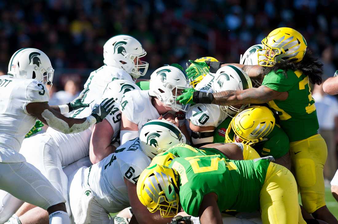 Spartans QB Brian Lewerke (14) gains the first down. Oregon Ducks Football takes on Michigan State University at Levi&#8217;s Stadium in San Jose, CA. on Dec. 31, 2018. (Ben Green/Emerald)