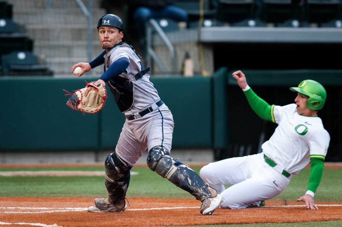 Saint Mary's cather Daniel Mendez (13) throws towards first to complete the double play. Oregon Ducks baseball takes on Saint Mary's University at PK Park in Eugene, Ore. on Feb. 22, 2019. (Ben Green/Emerald)