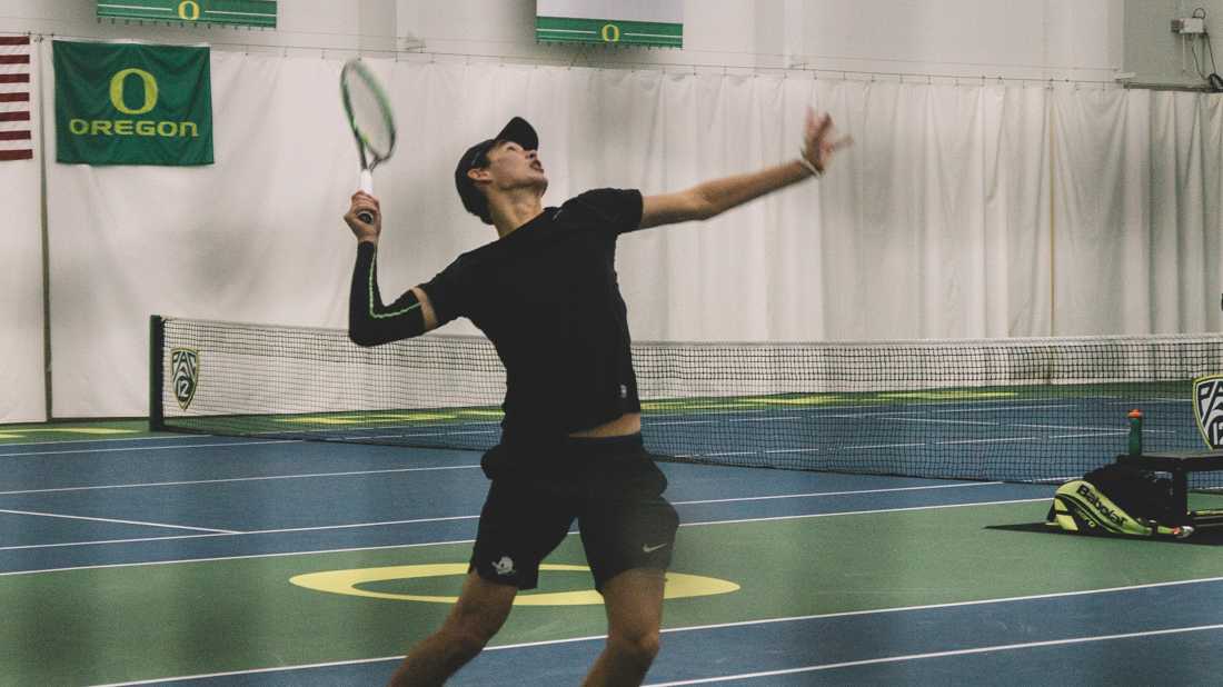 Sophomore Charles Roberts rises up to serve in a doubles match. Oregon Ducks men&#8217;s tennis takes on Boise State University at the Student Tennis Center in Eugene, Ore. on Feb. 08, 2019. (Connor Cox/Emerald)