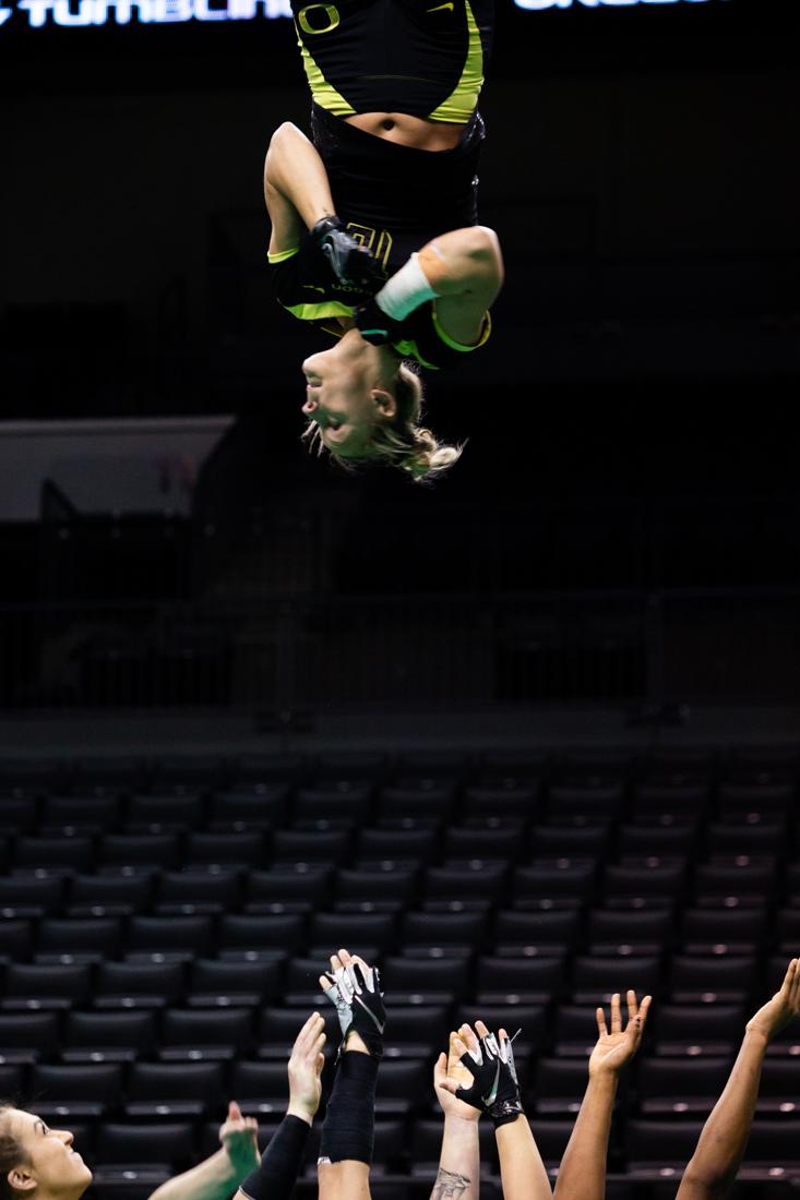 <p>Top Payton Coon (16) performs a twist during the toss. Ducks Acrobatics and Tumbling meets with Hawai'i Pacific at Matthew Knight Arena in Eugene, Ore. on Feb. 8, 2019. (Sarah Northrop/Emerald)</p>