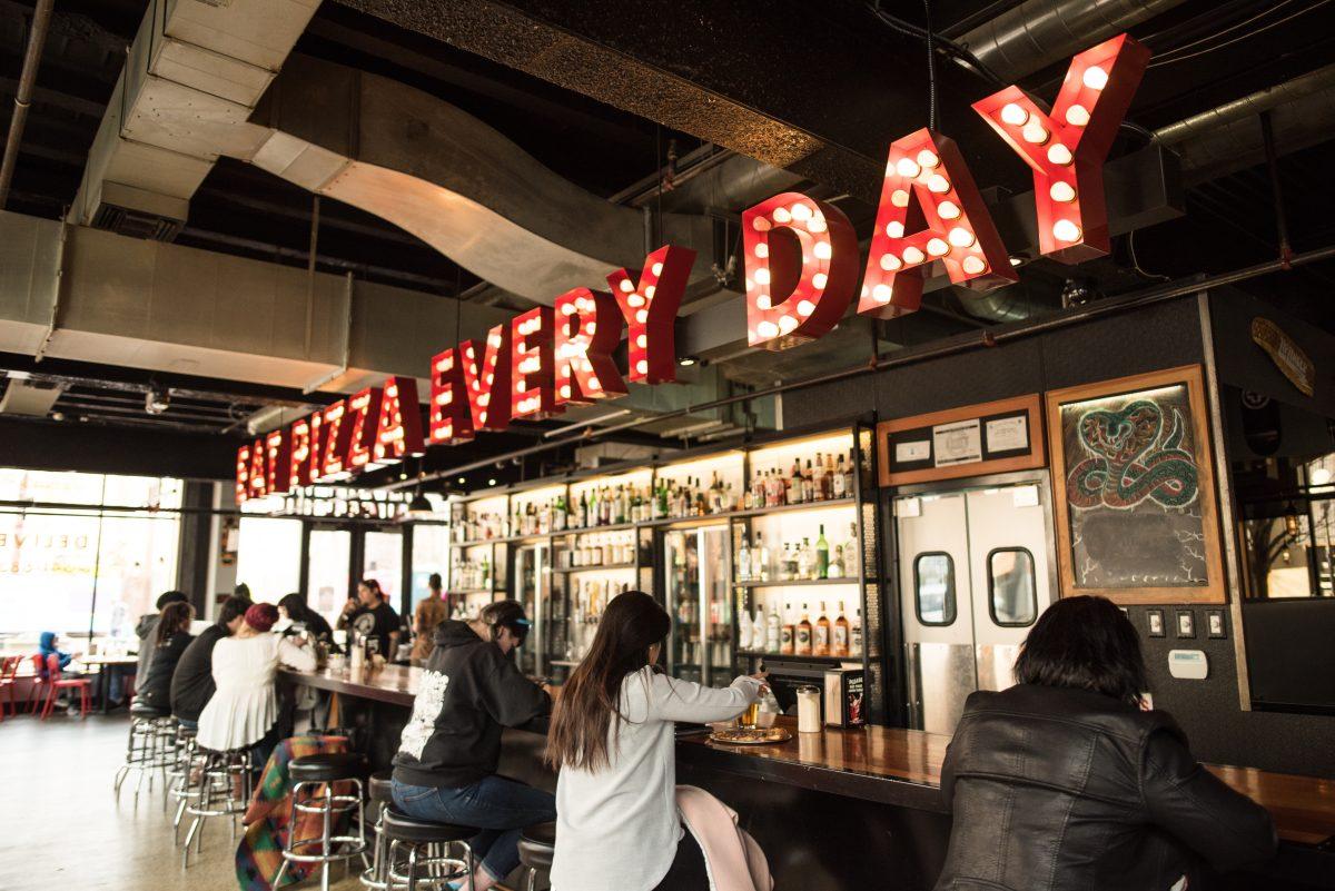 <p>EAT PIZZA EVERY DAY: Unique marquis-style lighted signs illuminate the inside and outside of Sizzle Pie, located in downtown Eugene, Ore. (Marissa Willke/Emerald)</p>