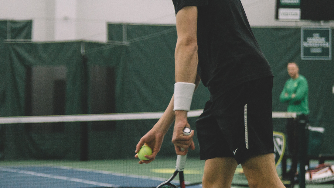 Ducks freshman Joshua Charlton prepares to serve. Oregon Ducks men&#8217;s tennis takes on Boise State University at the Student Tennis Center in Eugene, Ore. on Feb. 08, 2019. (Connor Cox/Emerald)