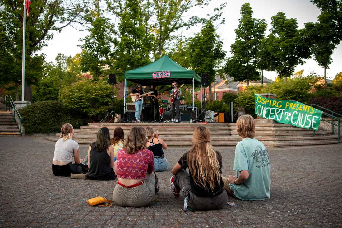 <p>Audience members enjoy the live music. Ospirg hosts a Concert for A Cause in the EMU Amphitheater on the University of Oregon campus in Eugene, Ore. on Jun. 4, 2019. (Maddie Knight/Emerald)</p>