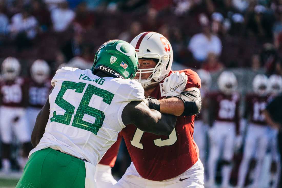 <p>Ducks linebacker Bryson Young battles with a Stanford linemen. Oregon Ducks football takes on the Stanford Cardinal at Stanford Stadium in Stanford, Calif. on Sept. 21, 2019. (Connor Cox/Emerald)</p>