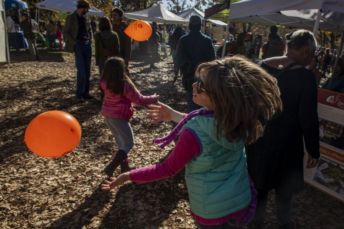 Harper Speck, right, and her friend Sequoia Rose, left play with balloons around the booths of the 2019 Mount Pisgah Arboretum Mushroom Festival on Sunday afternoon.