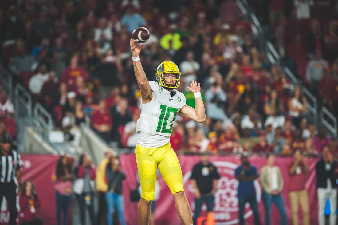 <p>Ducks quarterback Justin Herbert (10) throws on the run. Oregon Ducks Football takes on the Trojans at The Los Angeles Memorial Coliseum on Nov. 2, 2019. (DL Young/Emerald)</p>